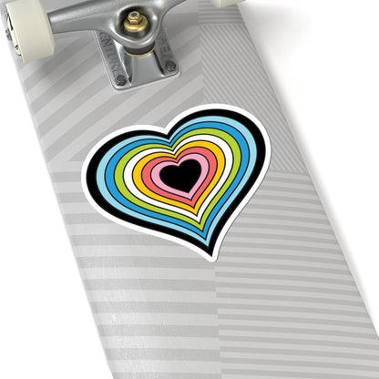 Close-up of the bottom of a silver skateboard featuring a 6 inch by 6 inch pride flag heart sticker in a Queer flag style applied to the surface.