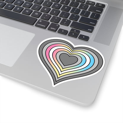 Close-up of the bottom right corner of a silver laptop featuring a 4 inch by 4 inch pride flag heart sticker in a Demifluid flag style applied to the surface.