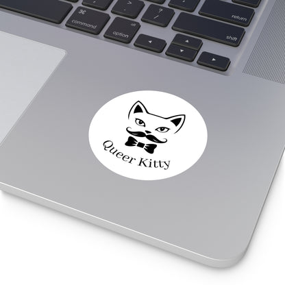 Laptop with a sticker featuring a cat face with a mustache and bow tie and the text 'Queer Kitty'.