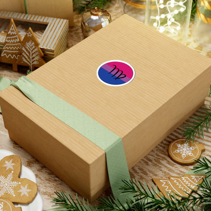 Gift box with a green ribbon on a festive background with cookies and Christmas decorations. Virgo Bisexual pride sticker centered on the box.