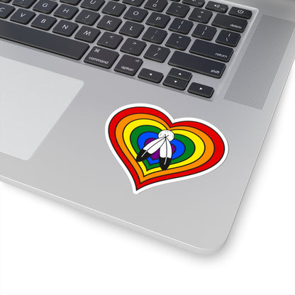 Close-up of the bottom right corner of a silver laptop featuring a 3 inch by 3 inch pride flag heart sticker in a Two-Spirit flag style applied to the surface.