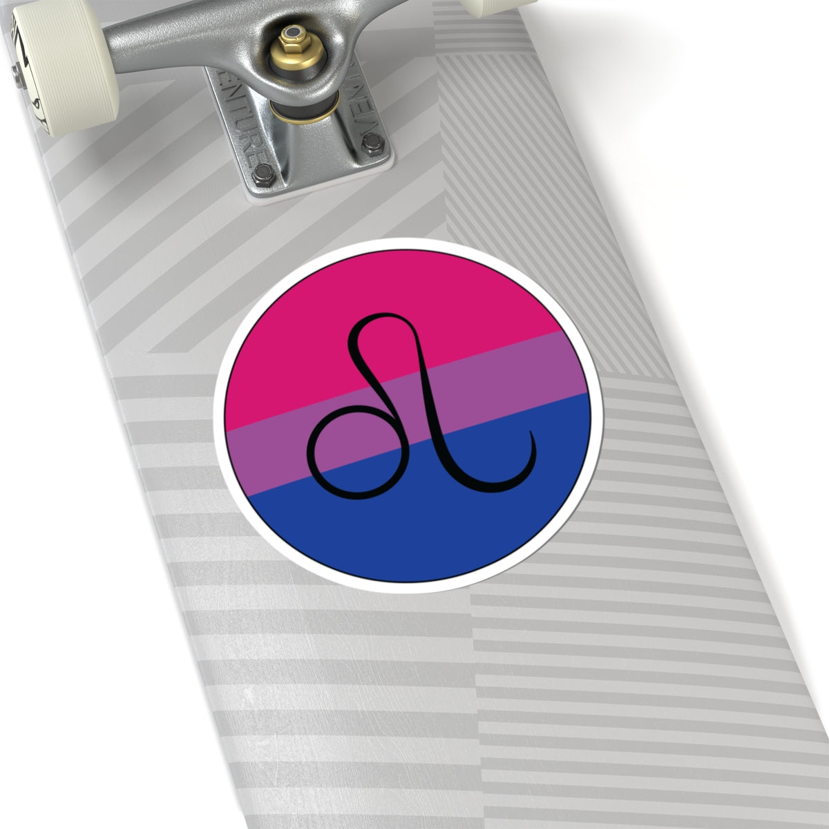 Close-up of the bottom of a silver skateboard featuring a 6 inch by 6 inch circular zodiac sticker with a centered Leo glyph on a Bisexual pride flag style background applied to the surface.