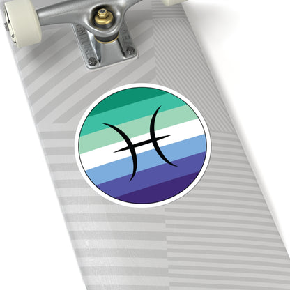 Close-up of the bottom of a silver skateboard featuring a 6 inch by 6 inch circular zodiac sticker with a centered Pisces glyph on a Gay Men pride flag style background applied to the surface.
