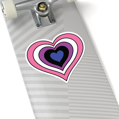 Close-up of the bottom of a silver skateboard featuring a 6 inch by 6 inch pride flag heart sticker in a Genderfluid flag style applied to the surface.