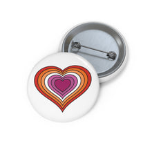 Front and back view of a white circular button with a heart-shaped lesbian flag image. The button is shown on a white background.
