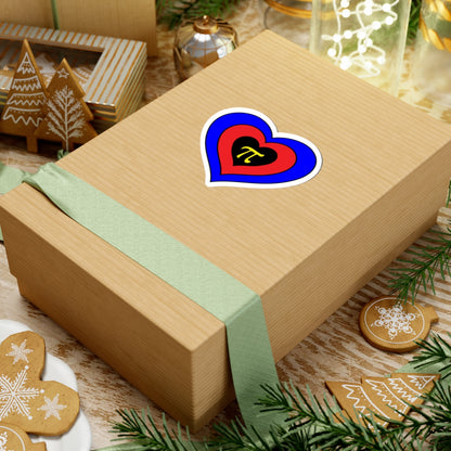 Gift box with a green ribbon on a festive background with cookies and Christmas decorations. Heart-shaped Polyamory pride sticker centered on the box.