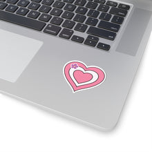 Close-up of the bottom right corner of a silver laptop featuring a 2 inch by 2 inch pride flag heart sticker in a Sapphic pride flag style applied to the surface.