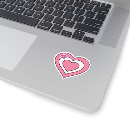 Close-up of the bottom right corner of a silver laptop featuring a 2 inch by 2 inch pride flag heart sticker in a Sapphic pride flag style applied to the surface.