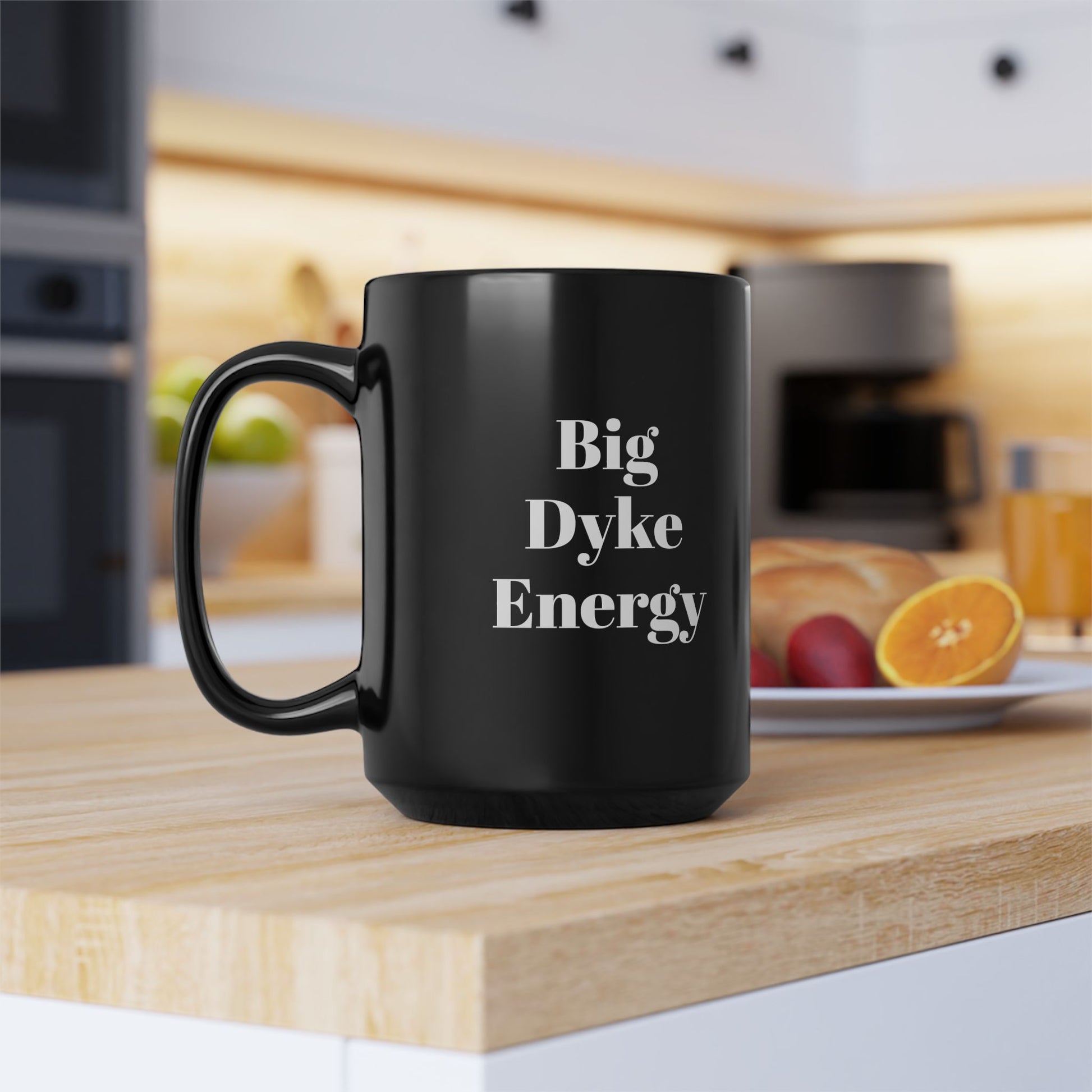 Black mug with 'Big Dyke Energy' text on a kitchen counter