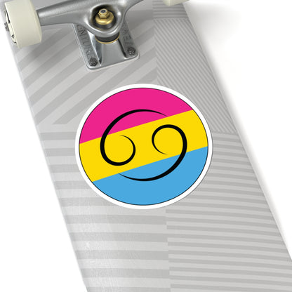 Close-up of the bottom of a silver skateboard featuring a 6 inch by 6 inch circular zodiac sticker with a centered Cancer glyph on a Pansexual pride flag style background applied to the surface.