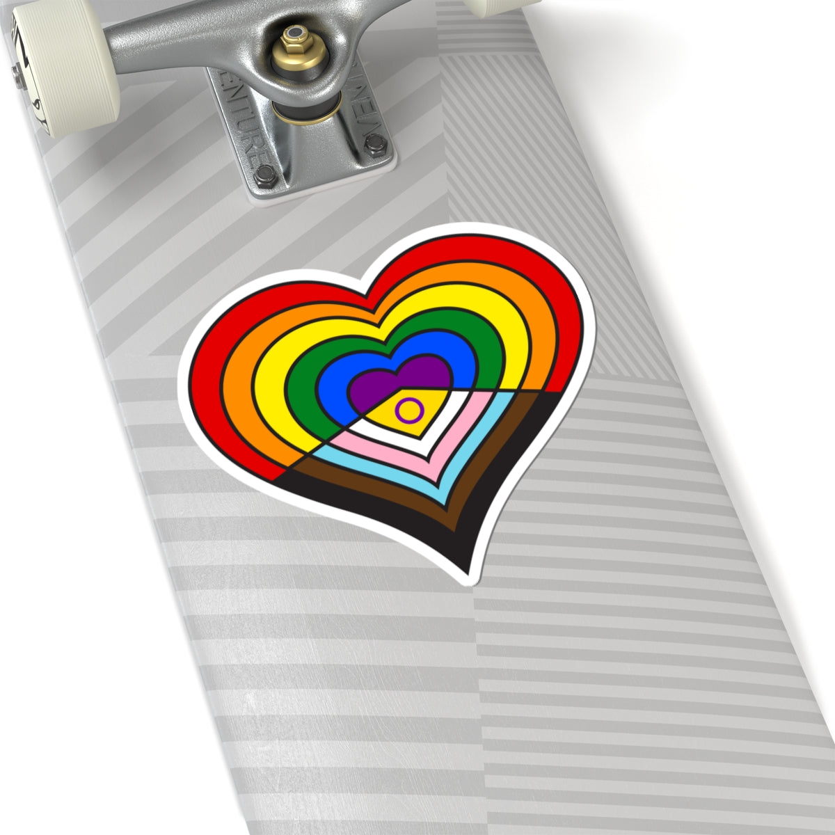 Close-up of the bottom of a silver skateboard featuring a 6 inches by 6 inches pride flag heart sticker in an Intersex-Inclusive Progress pride flag style applied to the surface.