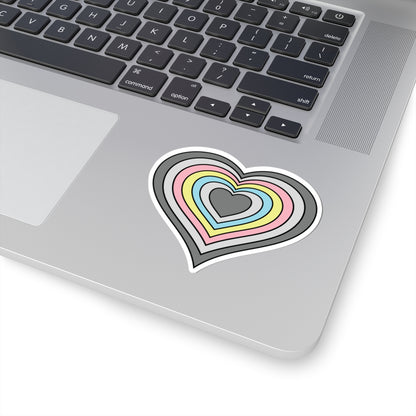 Close-up of the bottom right corner of a silver laptop featuring a 3 inch by 3 inch pride flag heart sticker in a Demiflux flag style applied to the surface.