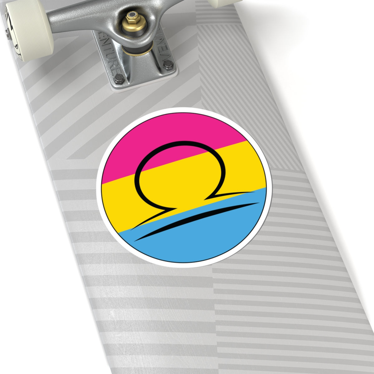 Close-up of the bottom of a silver skateboard featuring a 6 inch by 6 inch circular zodiac sticker with a centered Libra glyph on a Pansexual pride flag style background applied to the surface.
