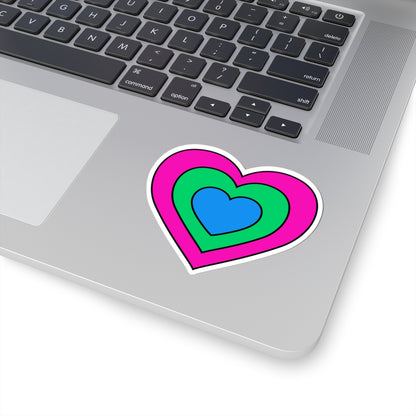 Close-up of the bottom right corner of a silver laptop featuring a 3 inch by 3 inch pride flag heart sticker in a Polysexual flag style applied to the surface.