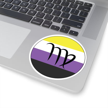 Close-up of the bottom right corner of a silver laptop featuring a 4 inch by 4 inch circular zodiac sticker with a centered Virgo glyph on a Nonbinary pride flag style background applied to the surface.