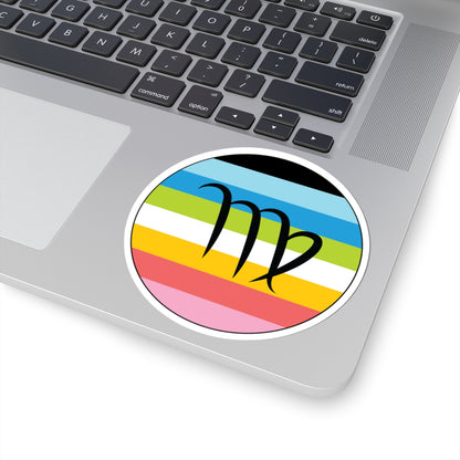 Close-up of the bottom right corner of a silver laptop featuring a 4 inch by 4 inch circular zodiac sticker with a centered Virgo glyph on a Queer pride flag style background applied to the surface.