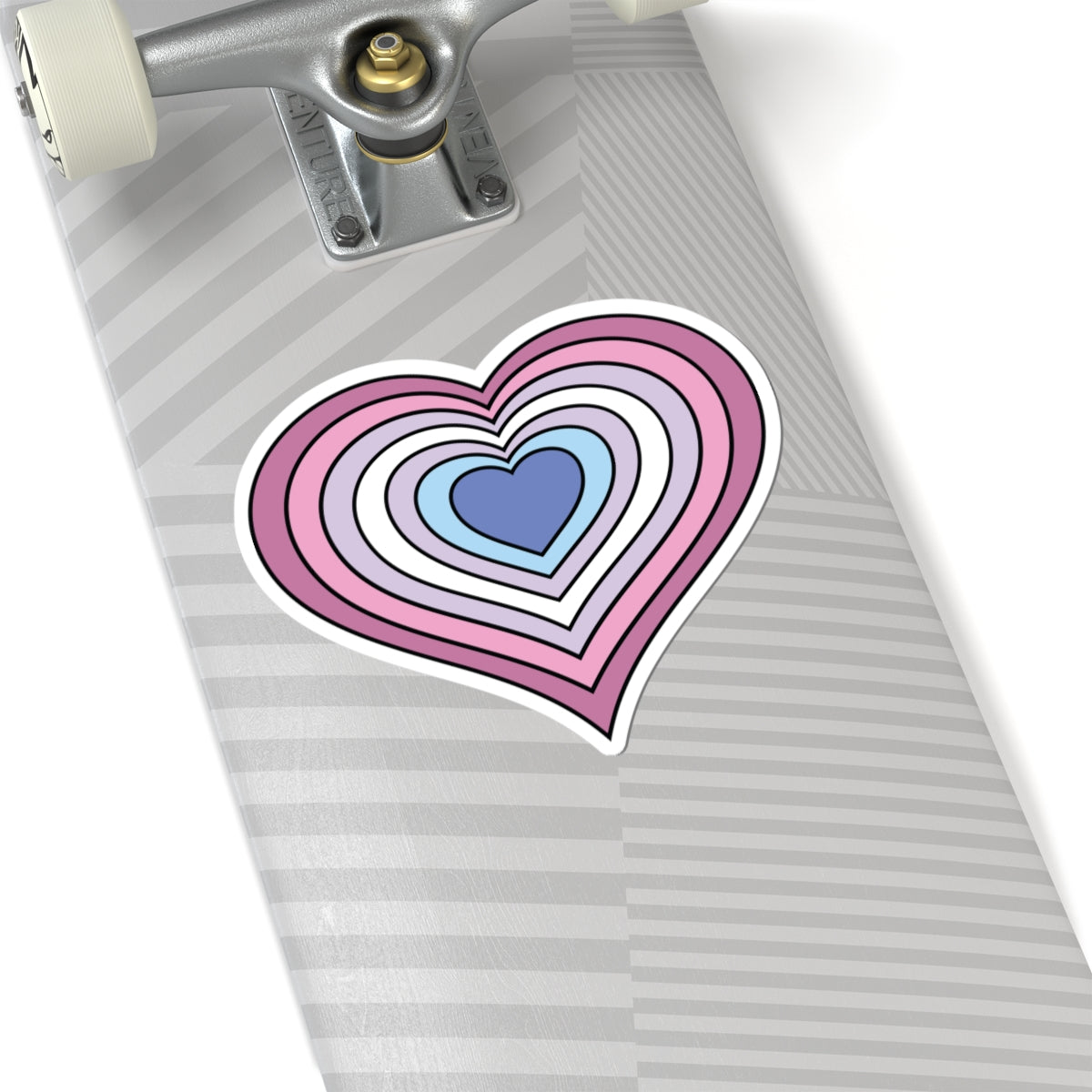 Close-up of the bottom of a silver laptop featuring a 6 inch by 6 inch pride flag heart sticker in a Bigender flag style applied to the surface.