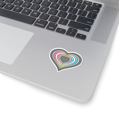 Close-up of the bottom right corner of a silver laptop featuring a 2 inch by 2 inch pride flag heart sticker in a Demifluid flag style applied to the surface.