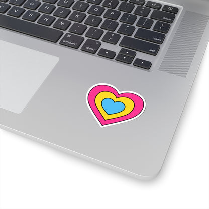 Close-up of the bottom right corner of a silver laptop featuring a 2 inch by 2 inch pride flag heart sticker in a Pansexual flag style applied to the surface.