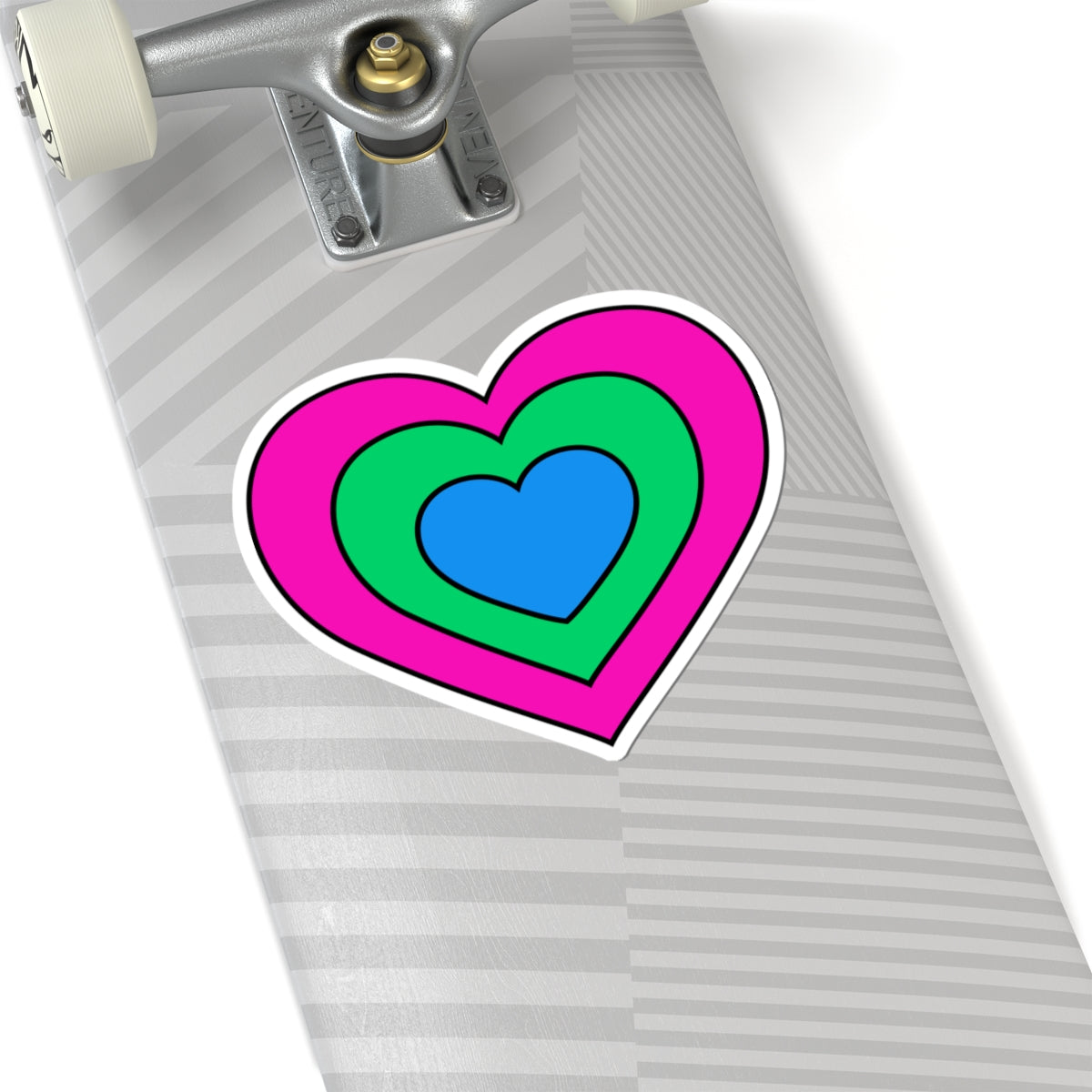 Close-up of the bottom right corner of a silver laptop featuring a 6 inch by 6 inch pride flag heart sticker in a Polysexual flag style applied to the surface.