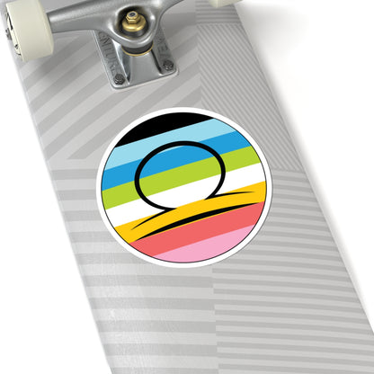 Close-up of the bottom of a silver skateboard featuring a 6 inch by 6 inch circular zodiac sticker with a centered Libra glyph on a Queer pride flag style background applied to the surface.