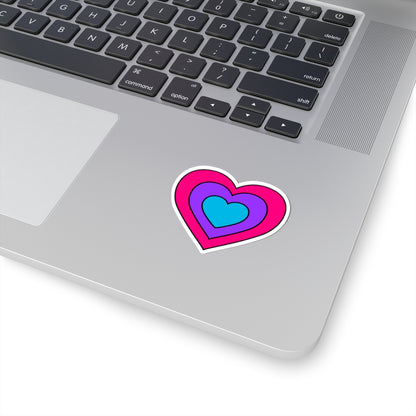 Close-up of the bottom right corner of a silver laptop featuring a 2 inch by 2 inch pride flag heart sticker in an Androgyne flag style applied to the surface.