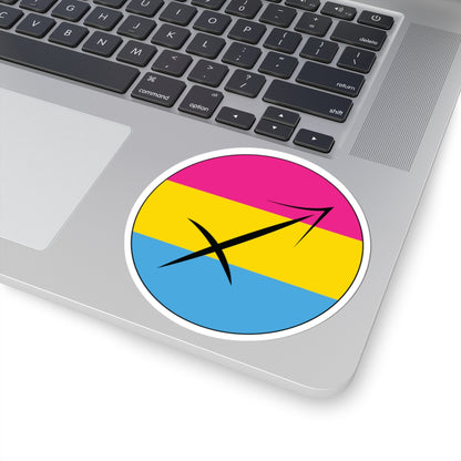 Close-up of the bottom right corner of a silver laptop featuring a 4 inch by 4 inch circular zodiac sticker with a centered Sagittarius glyph on a Pansexual pride flag style background applied to the surface.