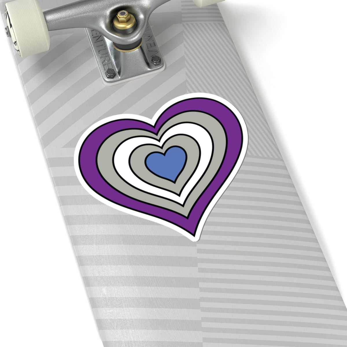 Close-up of the bottom of a silver skateboard featuring a 6 inch by 6 inch pride flag heart sticker in a Greysexual flag style applied to the surface.