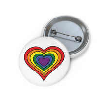 Front and back view of a circular pride button featuring a nested heart design inspired by the rainbow pride flag in red, orange, yellow, green, blue, and purple. The design has a thin black border, and the button is shown on a white background.