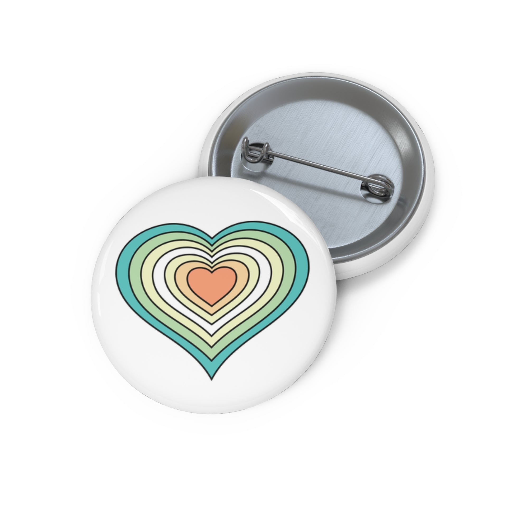 Front and back view of a white circular button with a heart-shaped genderfloren flag image. The button is shown on a white background.