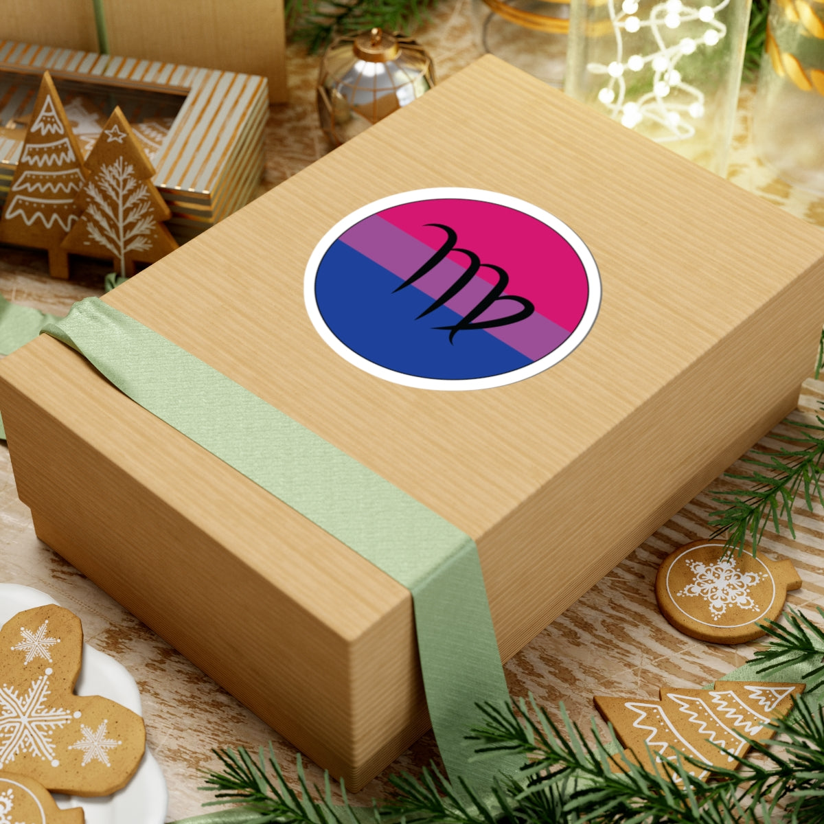 Gift box with a green ribbon on a festive background with cookies and Christmas decorations. Virgo Bisexual pride sticker centered on the box.