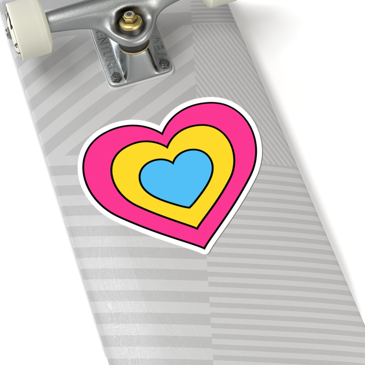 Close-up of the bottom of a silver skateboard featuring a 6 inch by 6 inch pride flag heart sticker in a Pansexual flag style applied to the surface.