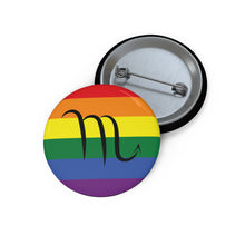 Front and back view of a circular rainbow pride flag button featuring the Scorpio zodiac symbol in black centered on the front.