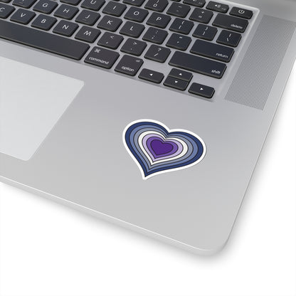 Close-up of the bottom of a silver skateboard featuring a 2 inch by 2 inch pride flag heart sticker in a purple butch pride flag style applied to the surface.