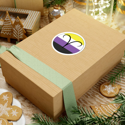 Gift box with a green ribbon on a festive background with cookies and Christmas decorations. Aires Nonbinary pride sticker centered on the box.