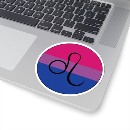 Close-up of the bottom right corner of a silver laptop featuring a 4 inch by 4 inch circular zodiac sticker with a centered Leo glyph on a Bisexual pride flag style background applied to the surface.