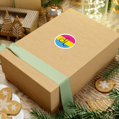 Gift box with a green ribbon on a festive background with cookies and Christmas decorations. Leo Pansexual pride sticker centered on the box.