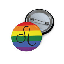 Front and back view of a circular rainbow pride flag button featuring the Leo zodiac symbol in black centered on the front.