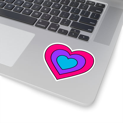 Close-up of the bottom right corner of a silver laptop featuring a 3 inch by 3 inch pride flag heart sticker in an Androgyne flag style applied to the surface.