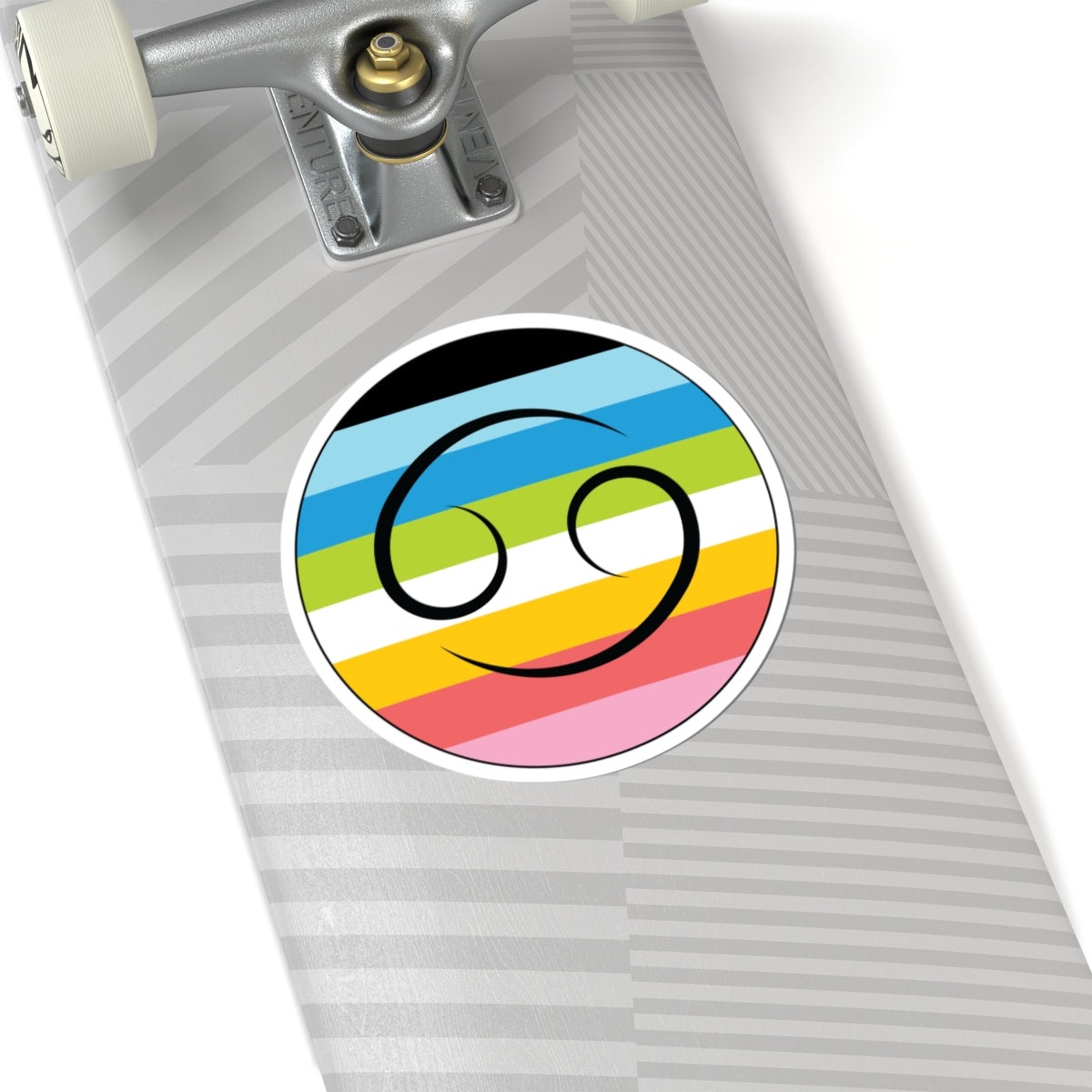 Close-up of the bottom of a silver skateboard featuring a 6 inch by 6 inch circular zodiac sticker with a centered Cancer glyph on a Queer pride flag style background applied to the surface.