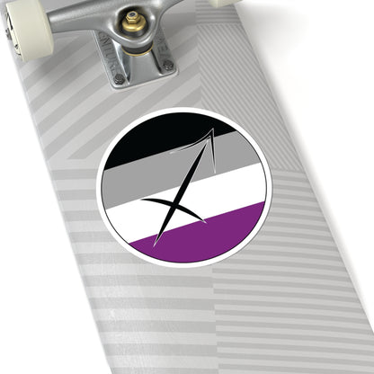 Close-up of the bottom of a silver skateboard featuring a 6 inch by 6 inch circular zodiac sticker with a centered Sagittarius glyph on an Asexual pride flag style background applied to the surface.