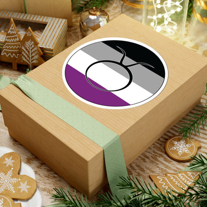 Gift box with a green ribbon on a festive background with cookies and Christmas decorations. Taurus Asexual pride sticker centered on the box.