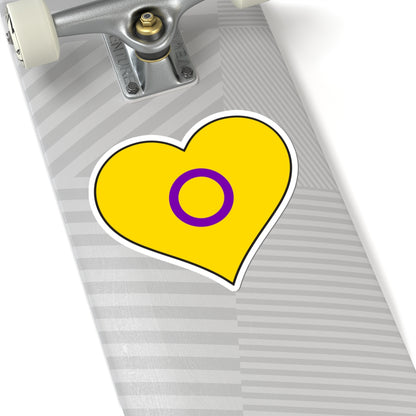 Close-up of the bottom of a silver skateboard featuring a 6 inch by 6 inch pride flag heart sticker in an Intersex flag style applied to the surface.