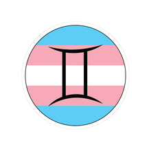 Circular transgender pride flag zodiac sticker with a thin black outline and white sticker border, featuring a centered black Gemini zodiac glyph. The sticker is shown on a white background.