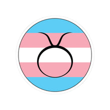 Circular transgender pride flag zodiac sticker with a thin black outline and white sticker border, featuring a centered black Taurus zodiac glyph. The sticker is shown on a white background.