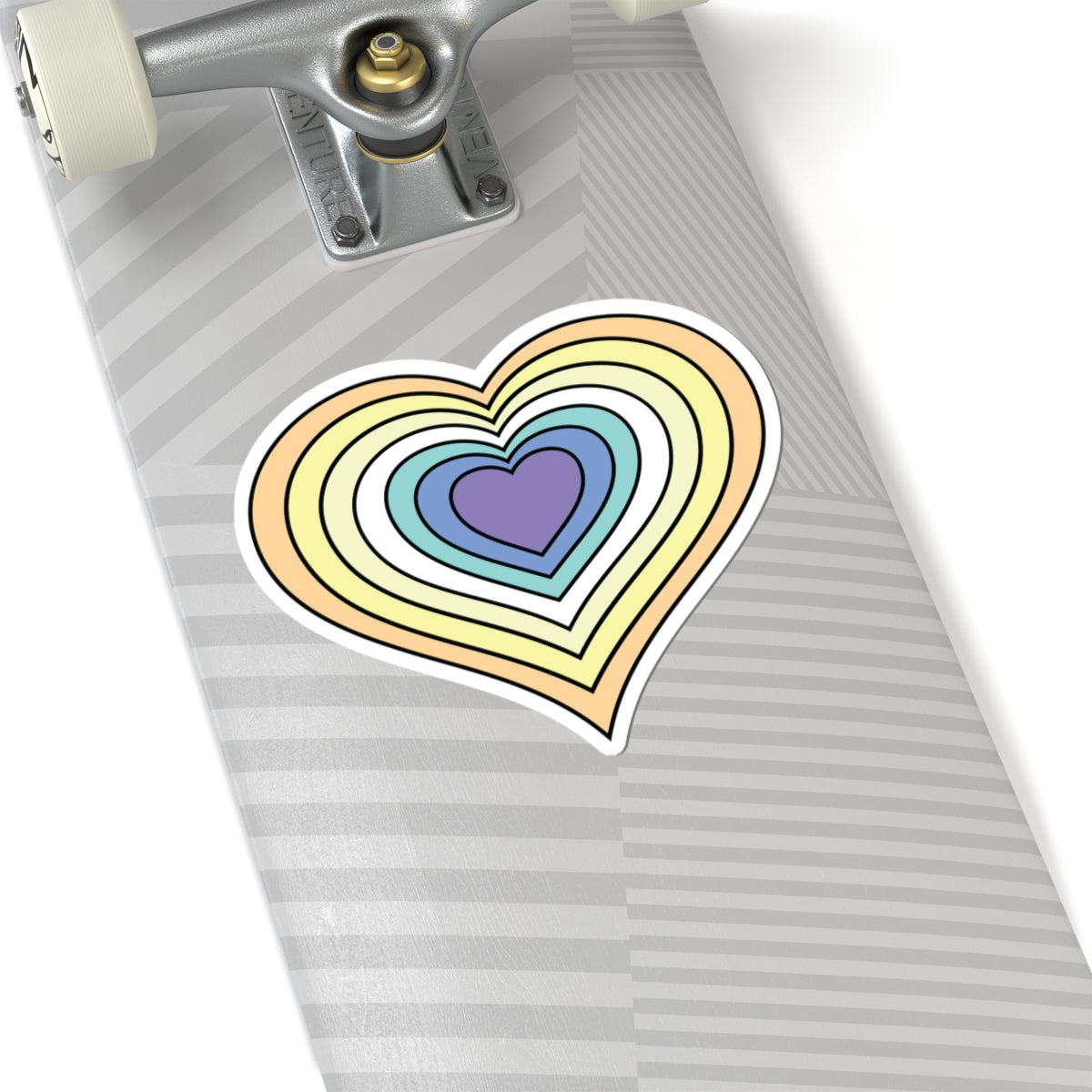 Close-up of the bottom of a silver skateboard featuring a 6 inch by 6 inch pride flag heart sticker in a Genderfaun flag style applied to the surface.