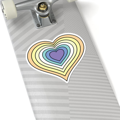 Close-up of the bottom of a silver skateboard featuring a 6 inch by 6 inch pride flag heart sticker in a Genderfaun flag style applied to the surface.