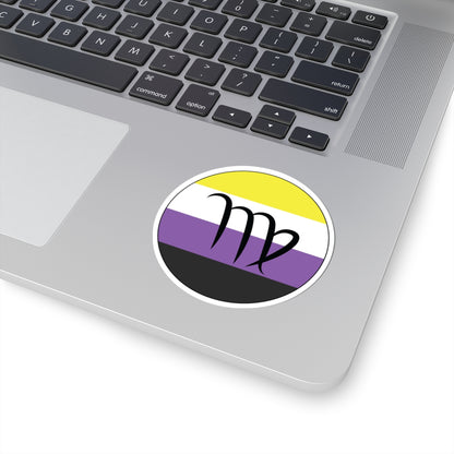 Close-up of the bottom right corner of a silver laptop featuring a 3 inch by 3 inch circular zodiac sticker with a centered Virgo glyph on a Nonbinary pride flag style background applied to the surface.