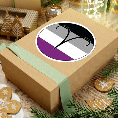 Gift box with a green ribbon on a festive background with cookies and Christmas decorations. Aires Asexual pride sticker centered on the box.