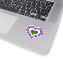 Close-up of the bottom right corner of a silver laptop featuring a 2 inch by 2 inch pride flag heart sticker in a Genderqueer flag style applied to the surface.